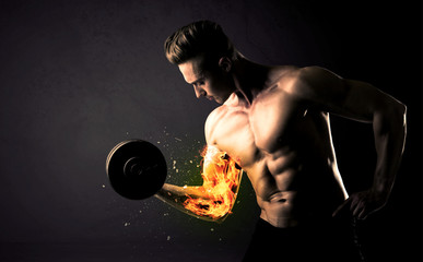 Bodybuilder athlete lifting weight with fire explode arm concept