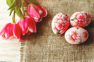 Decorated with painted Easter eggs and flowers on a light background