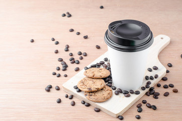 Coffee cup and coffee beans on wooden background