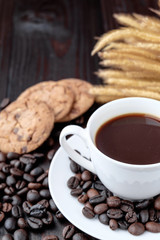 Coffee cup and coffee beans on wooden background