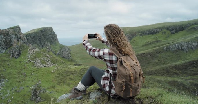 Woman hiker taking photo smartphone photographing scenic landscape nature background view enjoying vacation travel adventure