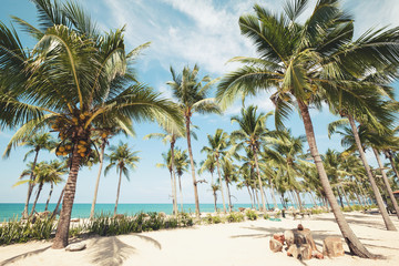 Landscape of coconut palm tree on tropical beach in summer - vintage color tone effect.