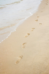 Fototapeta na wymiar Foot print on sand at the beach background