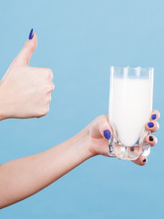 Woman hand holding glass of milk