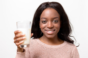 Young woman drinking a glass of fresh milk