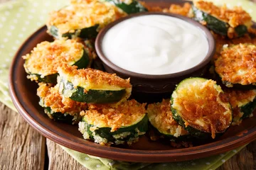  Spicy fried zucchini in breadcrumbs Panko and sour cream close-up. horizontal © FomaA