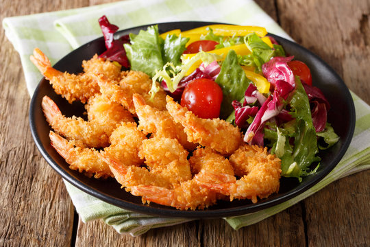 Fototapeta Fried shrimps tempura and fresh salad close-up on a plate. horizontal