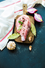 raw meat with spices on cutting board