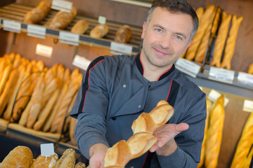 Baker showing baguette