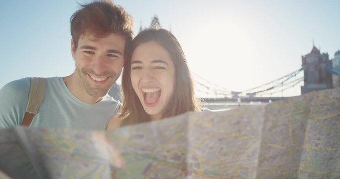 Tourist couple reading City Map planning European holiday Summer Vacation