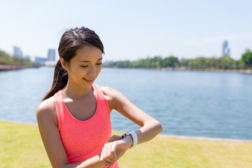Sport woman using smart watch to record the training