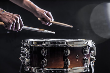 man plays musical percussion instrument with sticks, a musical concept, beautiful lighting on the stage