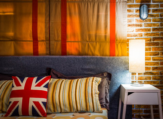 Obraz na płótnie Canvas lamp on night table next to bed, cozy living. bedroom interior
