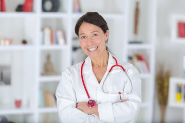 beautiful smiling female doctor sitting at the desk