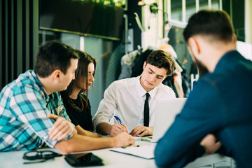 Startup teamwork brainstorming meeting concept. People working planning start up. Group young people Explaning and discussing and make notice in notebook