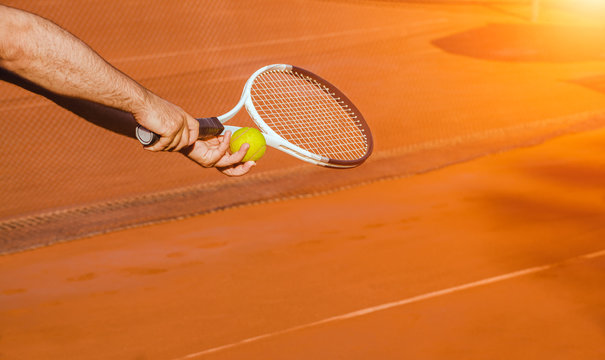 tennis player getting ready to serve the ball on court