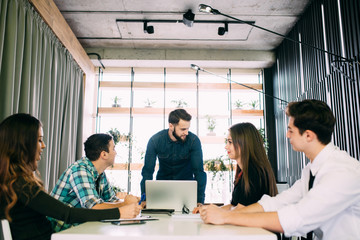 Young group of people discussing business plans.
