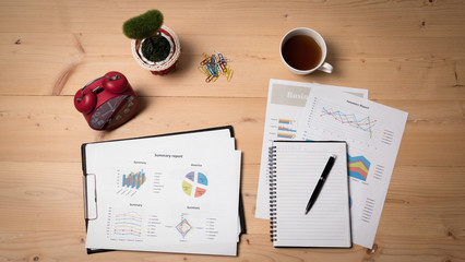 Top view of business document with cup of coffee at workplace in the morning.