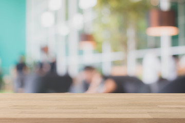 Wood table top and blurred restaurant interior background - can used for display or montage your products.