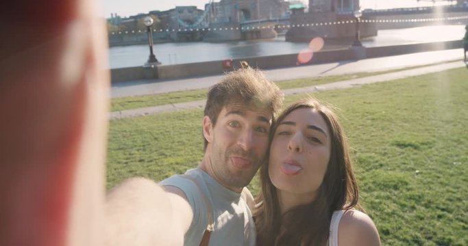 Tourist couple taking selfie smartphone in city sharing lifestyle photo enjoying  holiday European   vacation travel adventure London POV