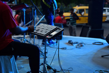 Young man playing electric drum pad