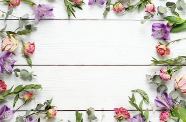Frame from the pattern of dried flowers on a white wooden background.Top view.Copy space. 