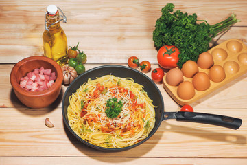 Tasty spaghetti with tomato sauce and meat in pan on wooden table.