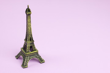 Fototapeta na wymiar Souvenir Eiffel Tower on pink paper background.