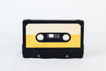 Old audio cassette isolated on white background. Historical records sound on a magnetic tape. Place for your text.