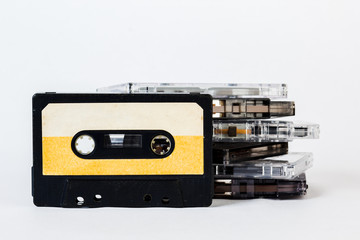 Fototapeta premium Old audio cassette isolated on white background. Historical records sound on a magnetic tape. Place for your text.