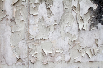 Vintage background texture of old brick masonry on ancient cement with cracks with traces of old paint.
