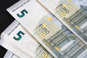  Euro banknotes and coins lie on top of each other