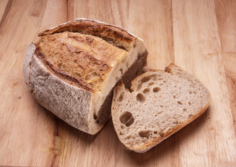 Rustic bread on an wooden table. Country house style. Authentically.