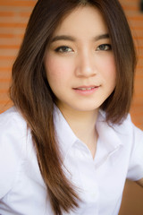 Portrait of thai adult student university uniform beautiful girl relax and smile