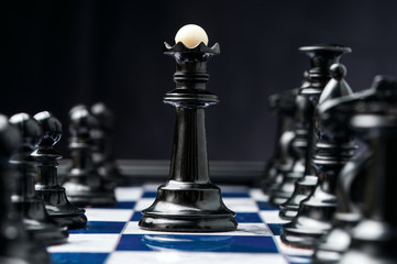 chess king among his black pieces