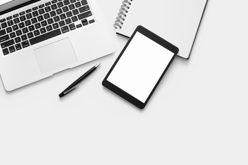 Laptop, tablet and office supplies on white background