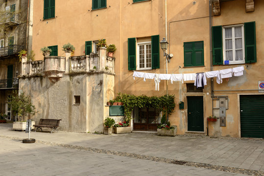drying laundry and old balcony, Finalborgo, Italy