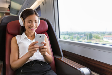 Modern people city lifestyle. Young urban woman using phone app and wireless headphones to listen...