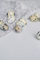 Scattered quail eggs on a linen napkin. Prepare to Easter. Toned in cold scale