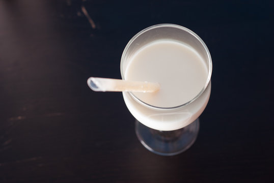 A glass of milk on a black background,