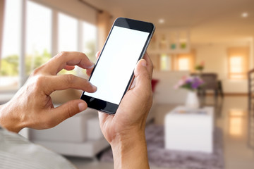 Man using smartphone at living room blur background.