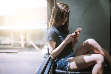 beautiful women playing smartphone in cafe coffee.