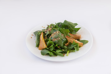 Dietary salad., Basil, pear, nuts oil. Plate isolated on white background