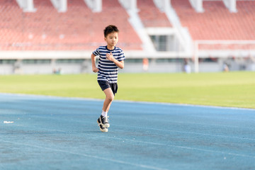 Boy running on the blue track