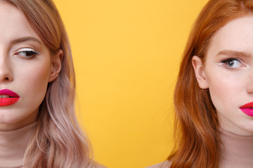 Cropped photo of young serious two ladies with bright makeup