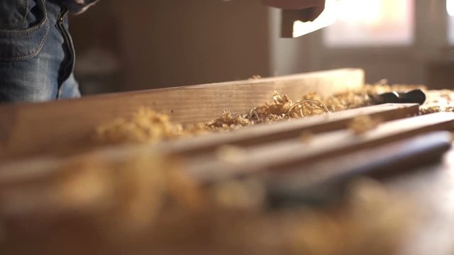 Carpenter planed wood, workplace. Slow motion