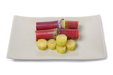 Short Stumps of Sugarcane in plate isolated on white background