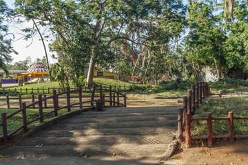 A concrete arch bridge with wooden support by side leading towards the garden, Chennai, Tamil nadu, India, Jan 29 2017