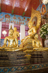 Obraz premium Sculpture of a seated Buddha on the altar of a buddhist temple of Wat Chanasongkram. Bangkok, Thailand