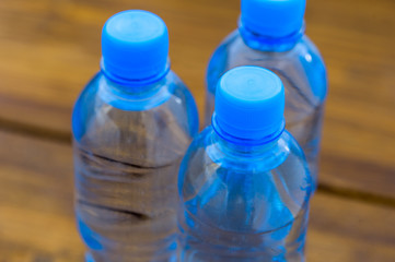 water in plastic bottles on a wooden table